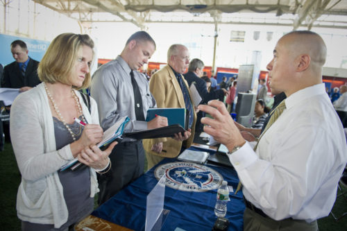 May 25, 2011 - Northeastern student Amy Fuentes (left) speaks to Ted Woo (right), Chief CBP Officer with the US Customs and Border Protection during the Veterans Job Fair inside Cabot Gymnasium at Northeastern University.  Fuentes served in the Marine Corps from 2001-2006 and is looking for a job when she graduates from Northeastern in December 2011.  The job fair served as an opportunity for employers to meet qualified veterans from the Greater Boston Area, including university students and graduates who are veterans of the U.S. Armed Forces.