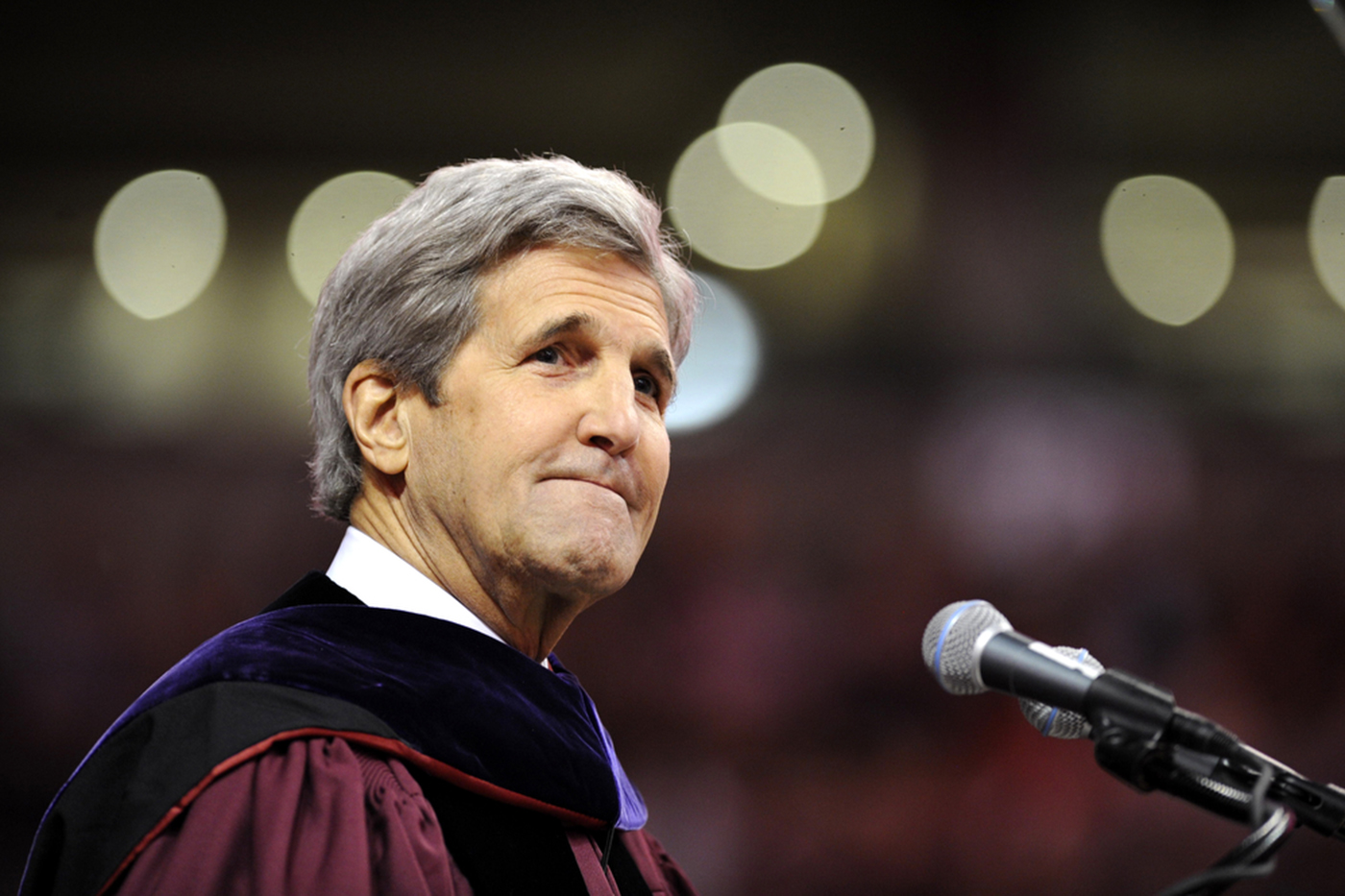John F. Kerry in Commencement regalia, speaking at the podium