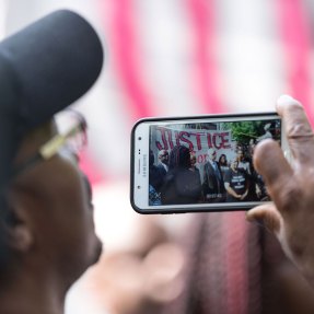 A spectator captures video of Minnesota Gov. Mark Dayton at a press conference on Thursday following the fatal police shooting of Philando Castile in a St. Paul suburb. Photo by Lorie Shaull/Flickr