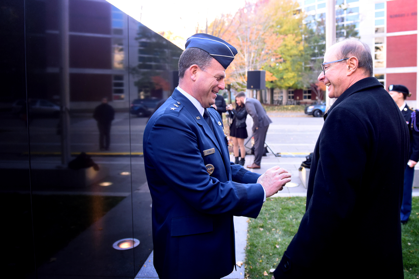 President Joseph E. Aoun, right, and Maj. Gen. Dwyer Dennis, program executive officer for C3I and networks at Hanscom Air Force Base, stand next to Northeastern’s Veterans Memorial on Neal F. Finnegan Plaza. <i>Photo by Matthew Modoono/Northeastern University</i>