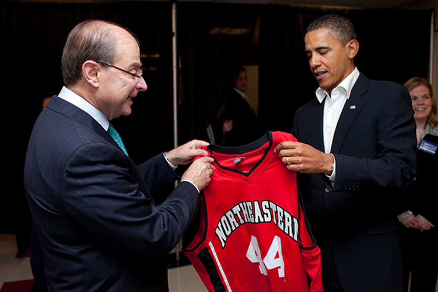 President Barack Obama is given a Northeastern #44 basketball jersey from Northeastern President Joseph E. Aoun prior to the event at Cabot Center. Official White House Photo by Pete Souza 