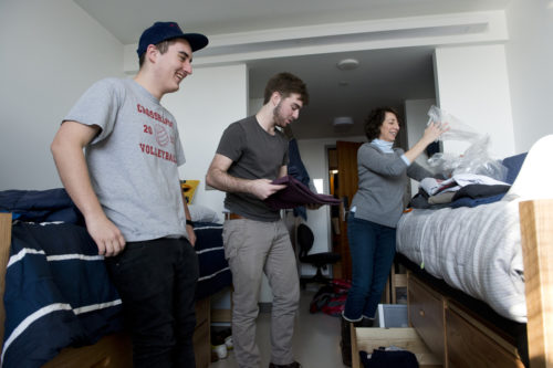 Students will begin selecting their campus housing for the fall semester as early as next week. Above, Travis Ketchum, left, and roommate Matt Winkel, DMSB'18, center, move into East Village in January 2015. <i>Photo by Brooks Canaday/Northeastern University</i>