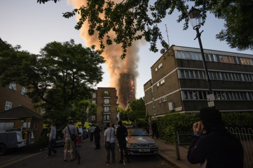 LONDON, UK- JUNE 14, 2017 Members of the public gather to watch a huge fire at the Grenfell tower block in west London. The blaze engulfed the 27-storey building with hundreds of firefighters attending the scene. There are reports of people trapped in the building and multiple fatalities. (Photo by Ben Cawthra) (Sipa via AP Images)