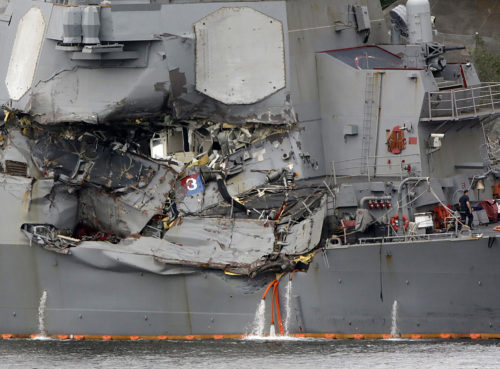 In this June 18, 2017 file photo, damaged section of the USS Fitzgerald is seen at the U.S. Naval base in Yokosuka, southwest of Tokyo.  The U.S. Navy has identified the seven sailors who died when their destroyer collided with a container ship off Japan on Saturday.(AP Photo/Eugene Hoshiko, File)