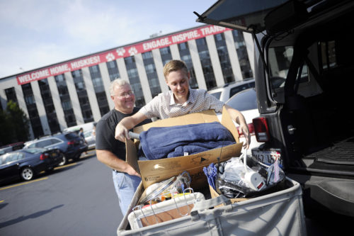 In this file photo from move-in in 2015, Duff Dimmig helps his son Harrison Dimmig, E'18, unload their car in the North Area Parking lot. Photo by Matthew Modoono/Northeastern University