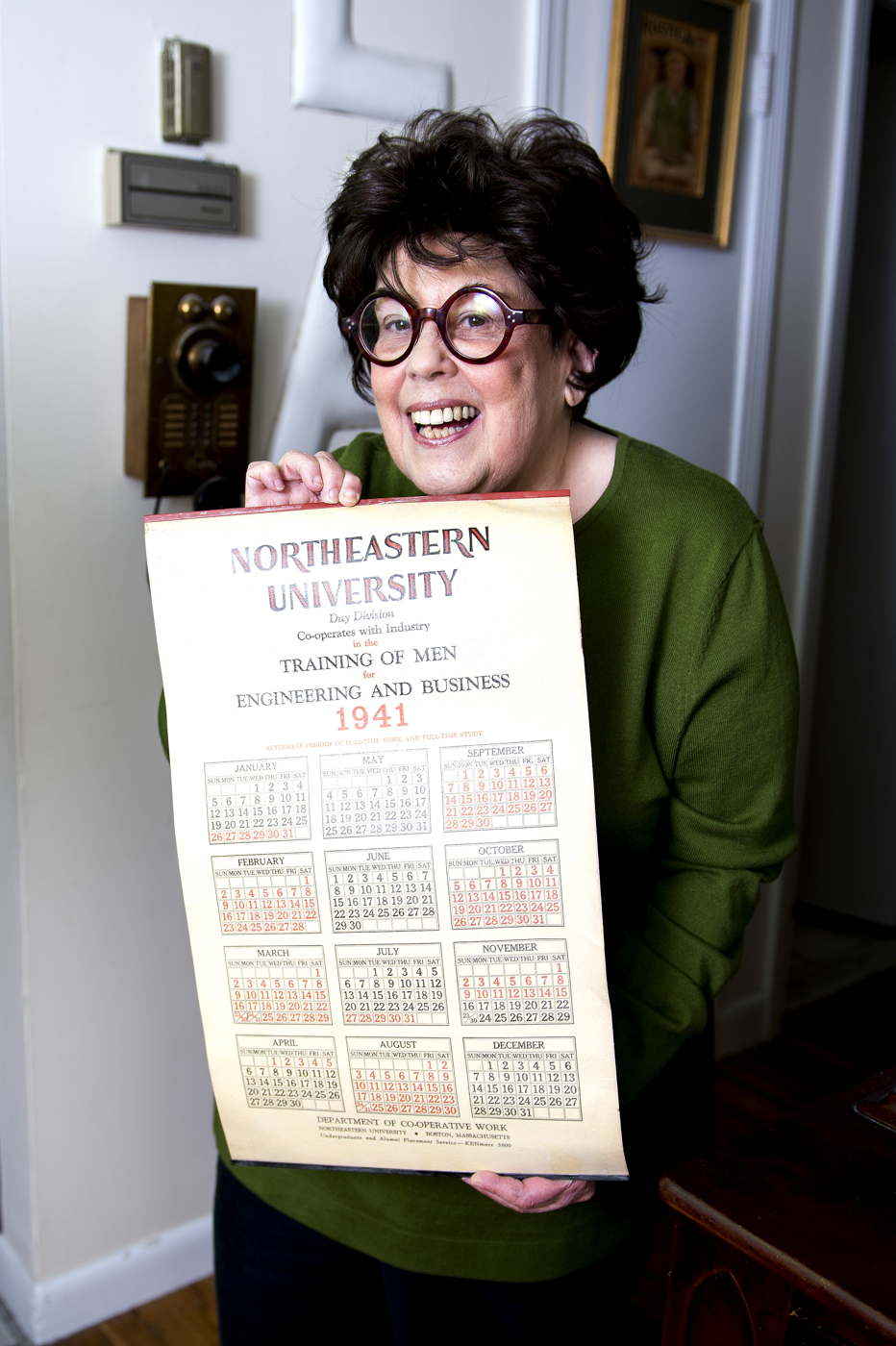 Marilynn Brass holds a vintage Northeastern calendar