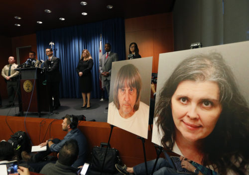 Riverside County District Attorney Mike Hestrin, at podium, takes questions from the media at a news conference regarding the couple accused of starving and torturing their 13 children in Riverside, Calif., Thursday, Jan. 18, 2018. Authorities say David and Louise Turpin could face charges including torture and child endangerment. (AP Photo/Damian Dovarganes)