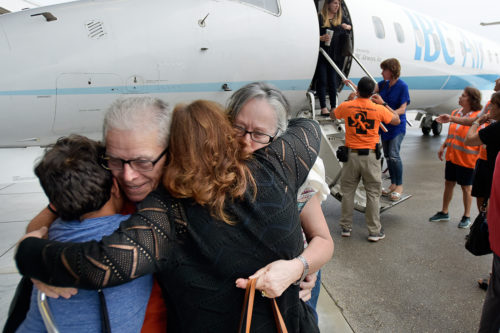 Angel and Ana Delgado hug family members after arriving at Fort Lauderdale/Hollywood International Airport, Friday, Sept. 29, 2017, on an IBC Airways flight that evacuated seniors from Puerto Rico. The flight was provided by a local nonprofit organization, the Pathfinders Task Force, through a program called Eagles Wings. (Michael Laughlin/South Florida Sun-Sentinel via AP)