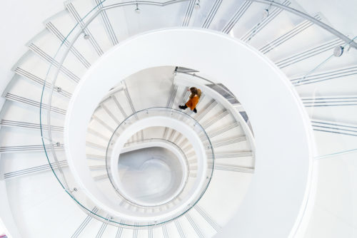 A student walks down the spiral staircase in the Interdisciplinary Science and Engineering Complex on Feb. 15, 2017. Photo by Adam Glanzman/Northeastern University