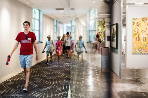 A tour group passes by Gallery 360 on July 5, 2018. Photo by Adam Glanzman/Northeastern University