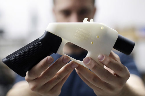 Cody Wilson holds a 3-D-printed gun called the Liberator at his shop in Austin, Texas. A federal judge in Seattle has issued a temporary restraining order to stop the release of blueprints to make untraceable and undetectable 3-D-printed plastic guns. (AP Photo/Eric Gay)