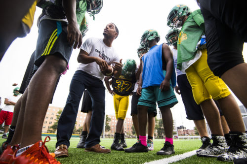 A youth football team practices on the newly renovated Carter playground field on September 13, 2018. Photo by Adam Glanzman/Northeastern University