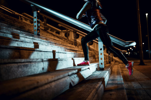 A woman runs up a set of stairs. Photo from iStock.