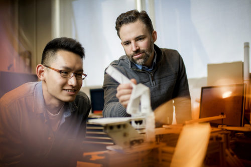 Assistant professor Samuel Felton and doctoral candidate Chang Liu recently published a paper demonstrating that origami structures can be transformed in less than one second. Photo by Matthew Modoono/Northeastern University
