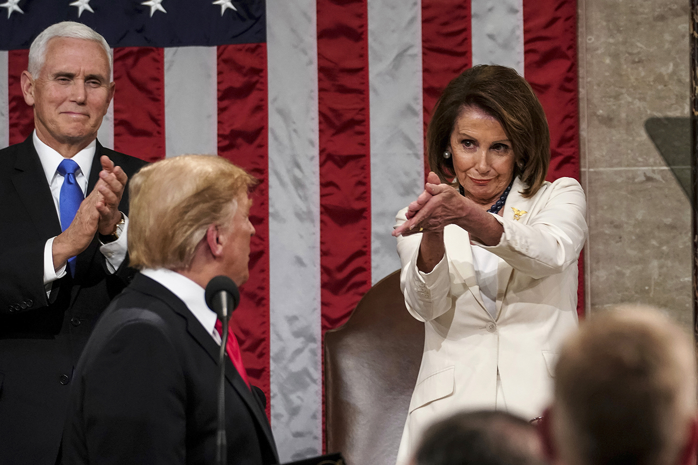 Nancy Pelosi claps in the direction of President Trump