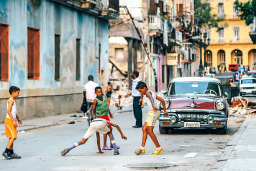 Cuban boys playing soccer in the streets of old Havana. Photo by iStock.