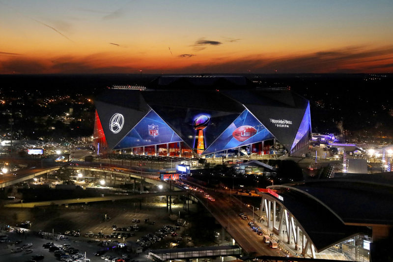The sun sets behind Mercedes-Benz Stadium ahead of Sunday's NFL Super Bowl 53 football game between the Los Angeles Rams and New England Patriots in Atlanta, Wednesday, Jan. 30, 2019. (AP Photo/David Goldman)