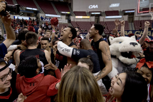 The Huskies celebrate their long-awaited admission to the Big Dance after defeating Hofstra, 82-74, to take the Colonial Athletic Association men‘s basketball final on March 12. Photo by Matthew Modoono/Northeastern University