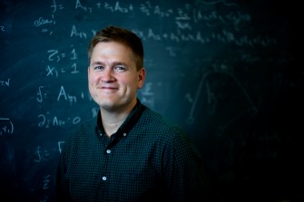 James Halverson, an assistant professor of physics at Northeastern, uses data science to study the many possibilities in string theory. Photo by Matthew Modoono/Northeastern University
