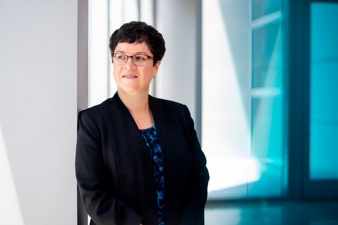 Carmen Sceppa, dean of Northeastern University’s Bouvé College of Health Sciences, stands by a window and looks to the side.