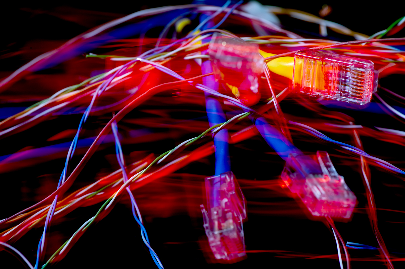 A new study by David Choffnes, an associate professor of computer and information science at Northeastern, found that almost all wireless carriers pervasively slow down internet speed for video streaming, even when networks are not overloaded. Stock photo of ethernet cables by Matthew Modoono/Northeastern University
