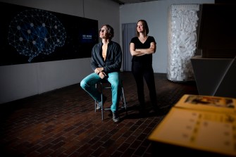 Professors pose at art exhibit
