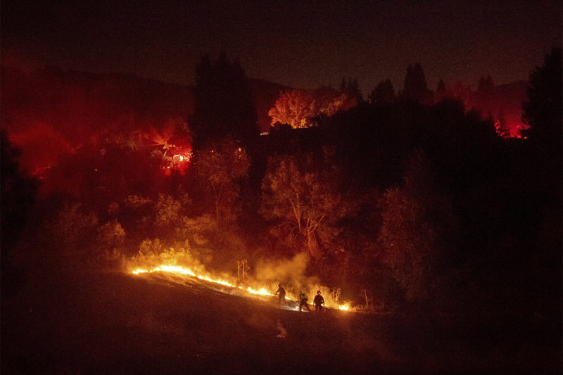Firefighters work to contain a wildfire burning off Merrill Dr. in Moraga, Calif., on Thursday, Oct. 10, 2019. Police have ordered evacuations as the fast-moving wildfire spread in the hills of the San Francisco Bay Area community. The area is without power after Pacific Gas & Electric preemptively cut service hoping to prevent wildfires during dry, windy conditions throughout Northern California. AP Photo/Noah Berger)