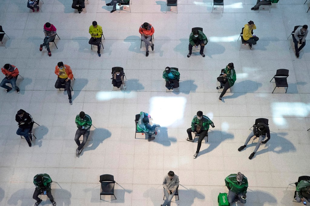 Shot of shoppers on spread-out chairs to prevent coronavirus spread