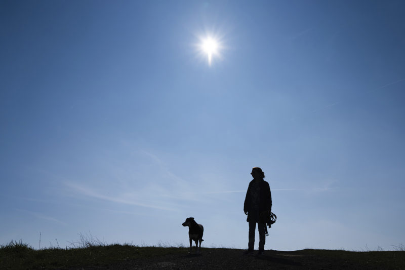 18 March 2020, Bavaria, D'ringstadt: A woman goes for a walk with her dog in sunny weather. Photo by: Nicolas Armer/picture-alliance/dpa/AP Images