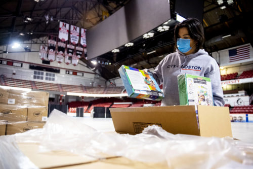 Pamela Leins, deputy commissioner of the Boston Centers for Youth and Families, unpacks donated art supplies at Matthews Arena to be disinfected and donated to Boston Public School children. Photo by Ruby Wallau/Northeastern University