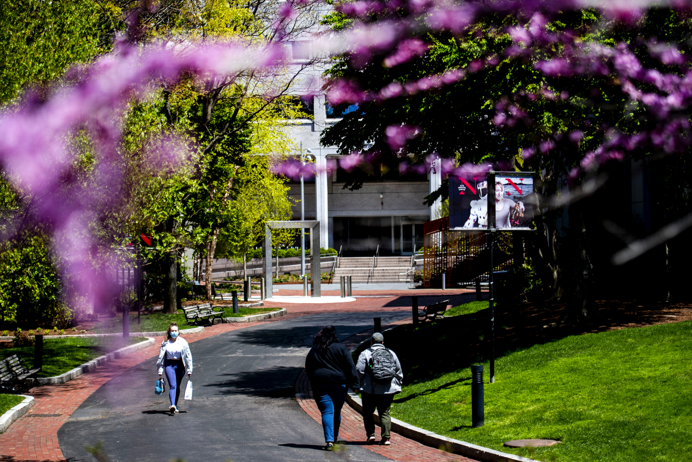 Spring colors frame people walking through the Boston campus. Photo by Ruby Wallau/Northeastern University