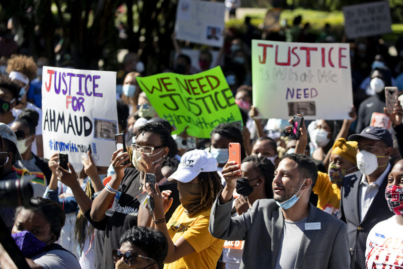 People react during a rally to protest the shooting of Ahmaud Arbery, an unarmed black man on May 8, 2020, in Brunswick, Georgia. Two men have been charged with murder in the February shooting death of Arbery, whom they had pursued in a truck after spotting him running in their neighborhood. AP Photo/John Bazemore