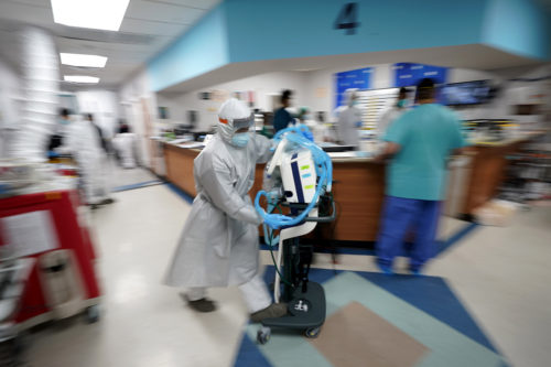 Medical equipment is rushed to a room as medical personnel try to save the life of a patient inside the Coronavirus Unit at United Memorial Medical Center on July 6, 2020, in Houston. AP Photo/David J. Phillip