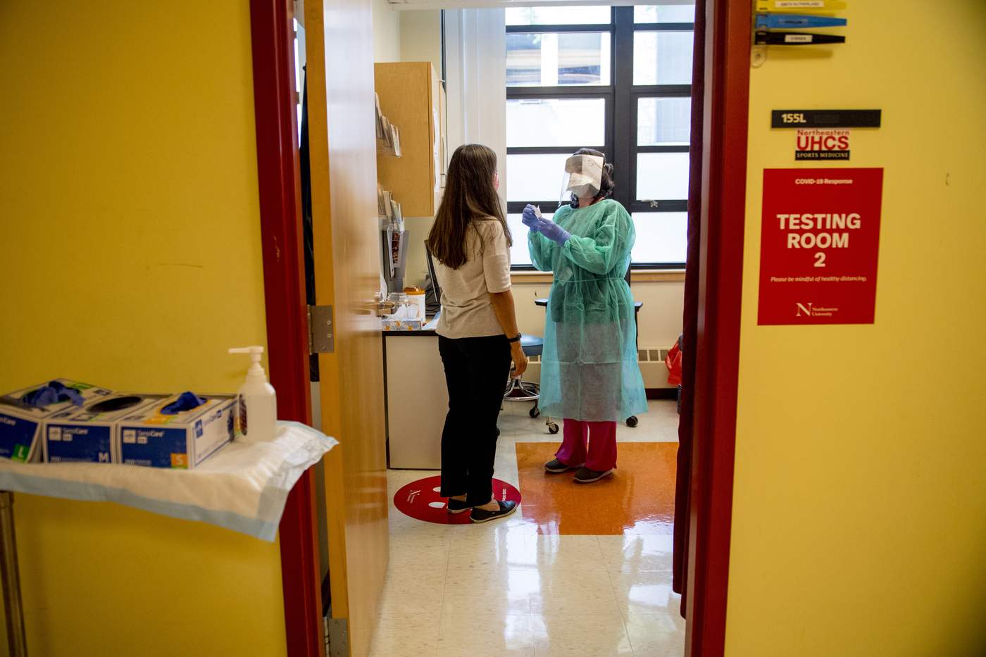 A nurse administers a coronavirus tests at Northeastern’s University Health and Counseling Services. 