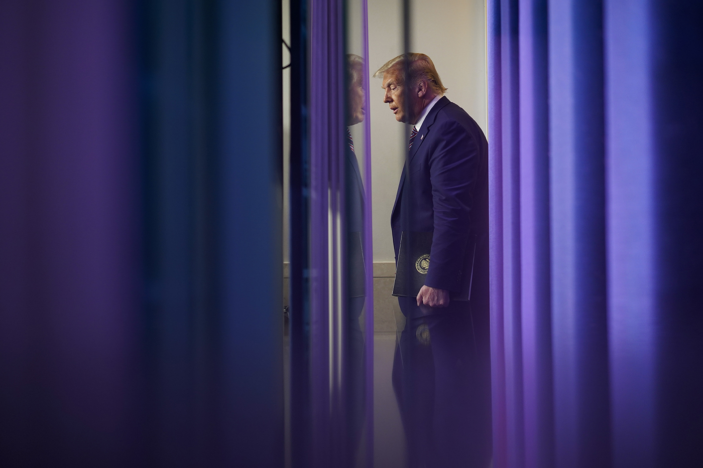 Trump walking down a hallway