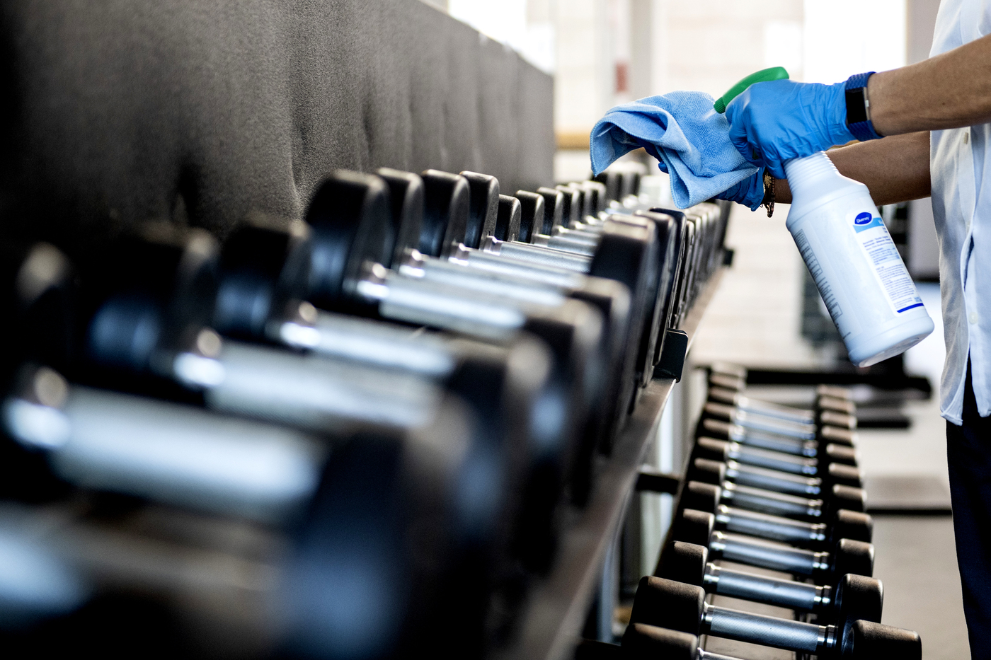 closeup of a person cleaning dumbells
