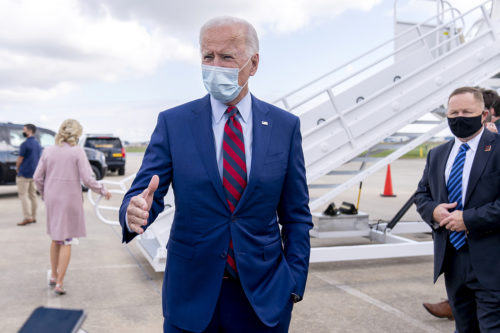 Democratic presidential candidate former Vice President Joe Biden speaks to members of the media outside his campaign plane at New Castle Airport in New Castle, Del., Monday, Oct. 5, 2020, to travel to Miami for campaign events. Also pictured is Jill Biden. AP Photo by Andrew Harnik