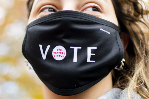 Ioanna Ploumi, who studies biology and political science, wears a Northeastern Votes face mask on Centennial Common on the day before Election Day. Northeastern Votes is a coalition of staff, faculty, and students working to educate students about the importance of civic engagement and how to get involved in this year’s national elections. Photo by Ruby Wallau/Northeastern University