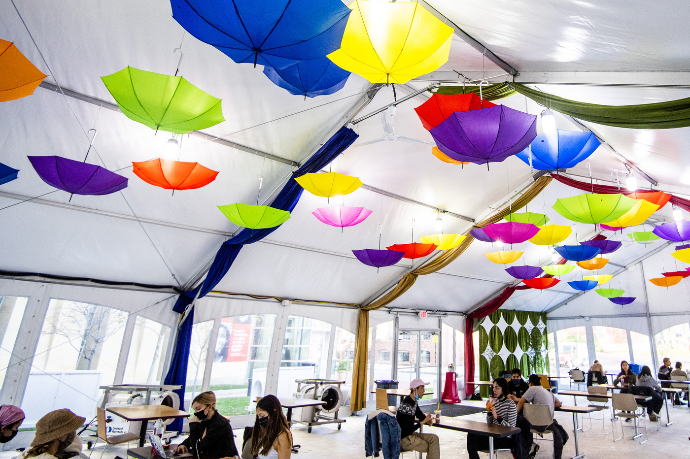 Colorful umbrella-shaped light fixtures adorn the ceiling of a dining tent outside the West Village complex on the Boston campus. Photo by Matthew Modoono/Northeastern University