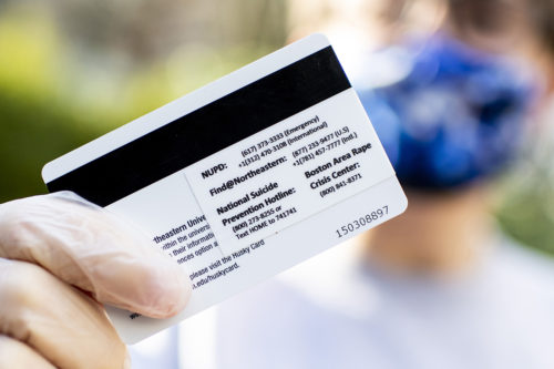 Members of Active Minds at Northeastern hand out mental health resource stickers for Husky Cards at Snell Quad. Photo by Ruby Wallau/Northeastern University