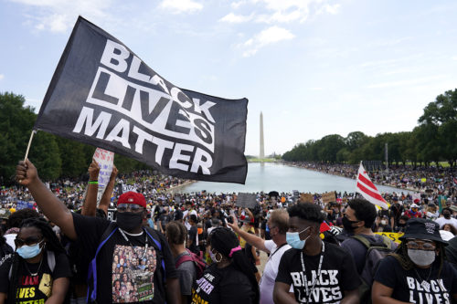 People attend the March on Washington on Aug. 28, 2020, in Washington, on the 57th anniversary of the Rev. Martin Luther King Jr.'s 