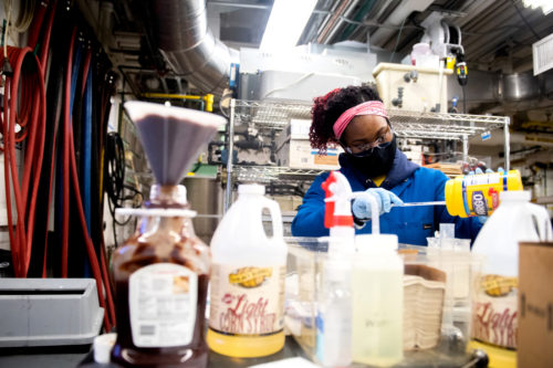 Lauryn Rodney, who studies chemical engineering, works on an experiment in the Mugar Life Sciences Building. Photo by Matthew Modoono/Northeastern University