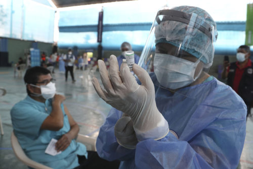 A nurse prepares a dose of China's Sinopharm vaccine during a priority COVID-19 vaccination of health workers at a public hospital in Lima, Peru, on Feb. 10, 2021. Peru received its first shipment of COVID-19 vaccines on Sunday night. AP Photo by Martin Mejia