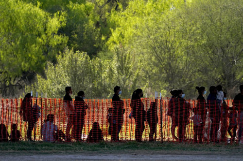 Migrants are seen in custody at a U.S. Customs and Border Protection processing area under the Anzalduas International Bridge on March 19, 2021, in Mission, Texas. AP Photo by Julio Cortez