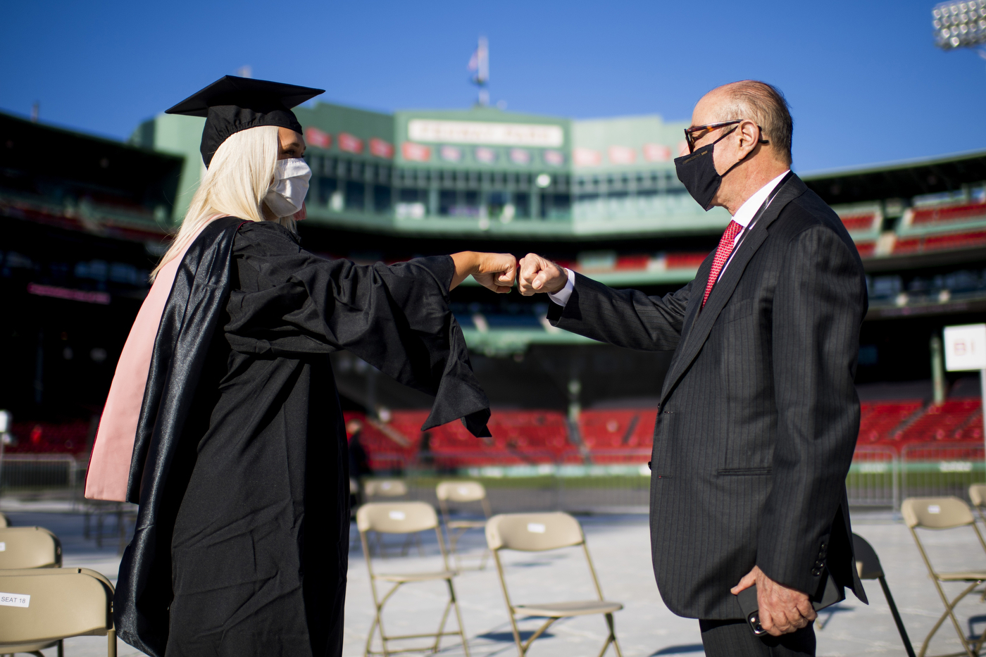 Joseph E. Aoun (right), president of Northeastern, would note “the power of human connection” in his speech to the graduate students at Fenway Park.