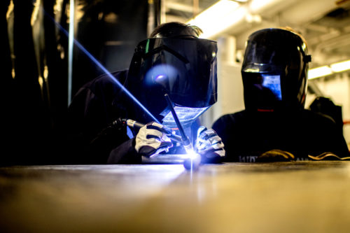 A student uses a laser to fabricate a race car.