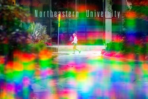 A members of the Northeastern community walk through campus. Photo by Matthew Modoono/Northeastern University