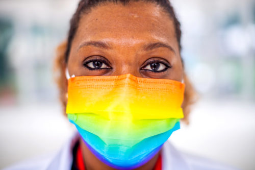 Northeastern’s Cabot Testing Center is awash this month in rainbow flags, stickers, and face masks to celebrate LGBTQA Pride Month, such as the one Iloisa Teixeira, a swab coach at Cabot, wears. Photo by Matthew Modoono/Northeastern University