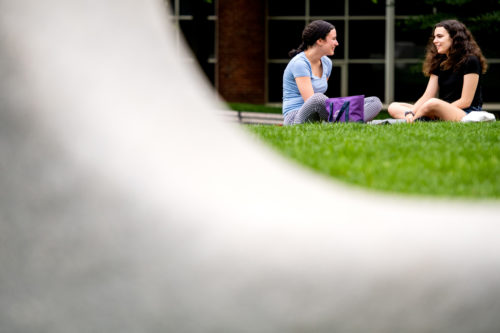 Lexi Feldman, who studies international affairs, and Ciara McKay, who studies music, relax on Centennial Common. Photo by Matthew Modoono/Northeastern University