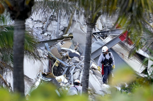 An investigator surveys the damage of the collapsed building in Surfside, Florida.